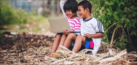 village children using laptop